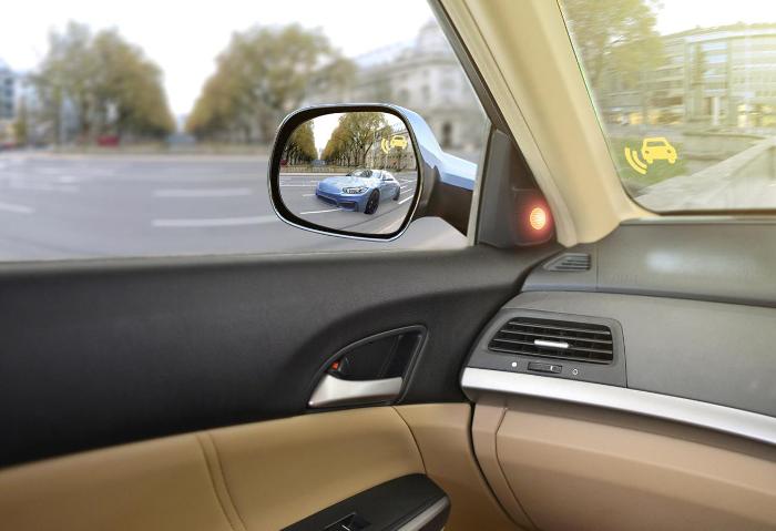 Car in wing mirror of car ahead